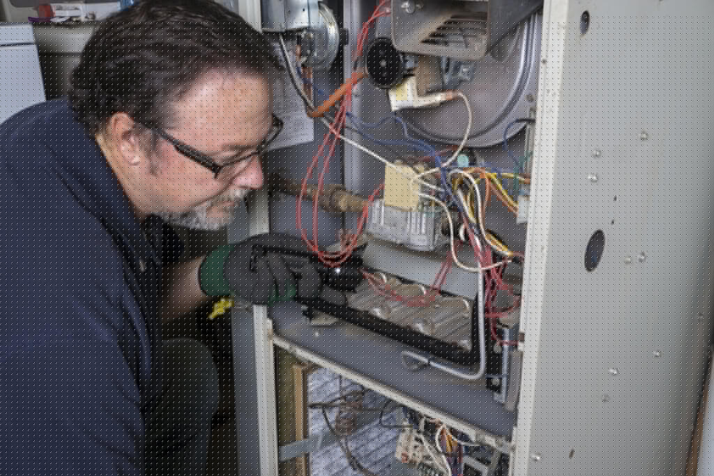 Lee’s technician diagnosing broken heat pump in Lafayette.