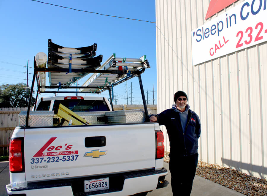Lee's Air Conditioning Company Professional Technician next to truck