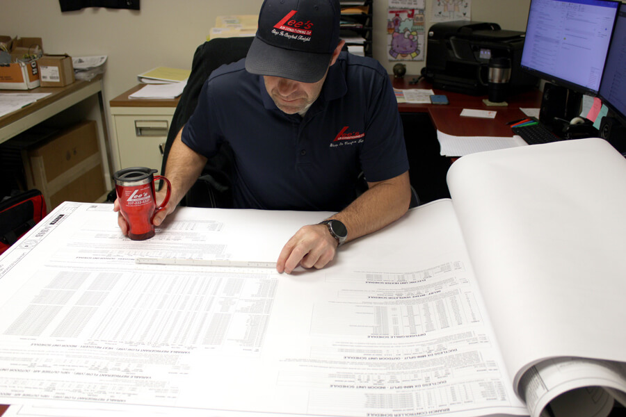 Lee's HVAC Technician Evaluating Air Conditioner Options