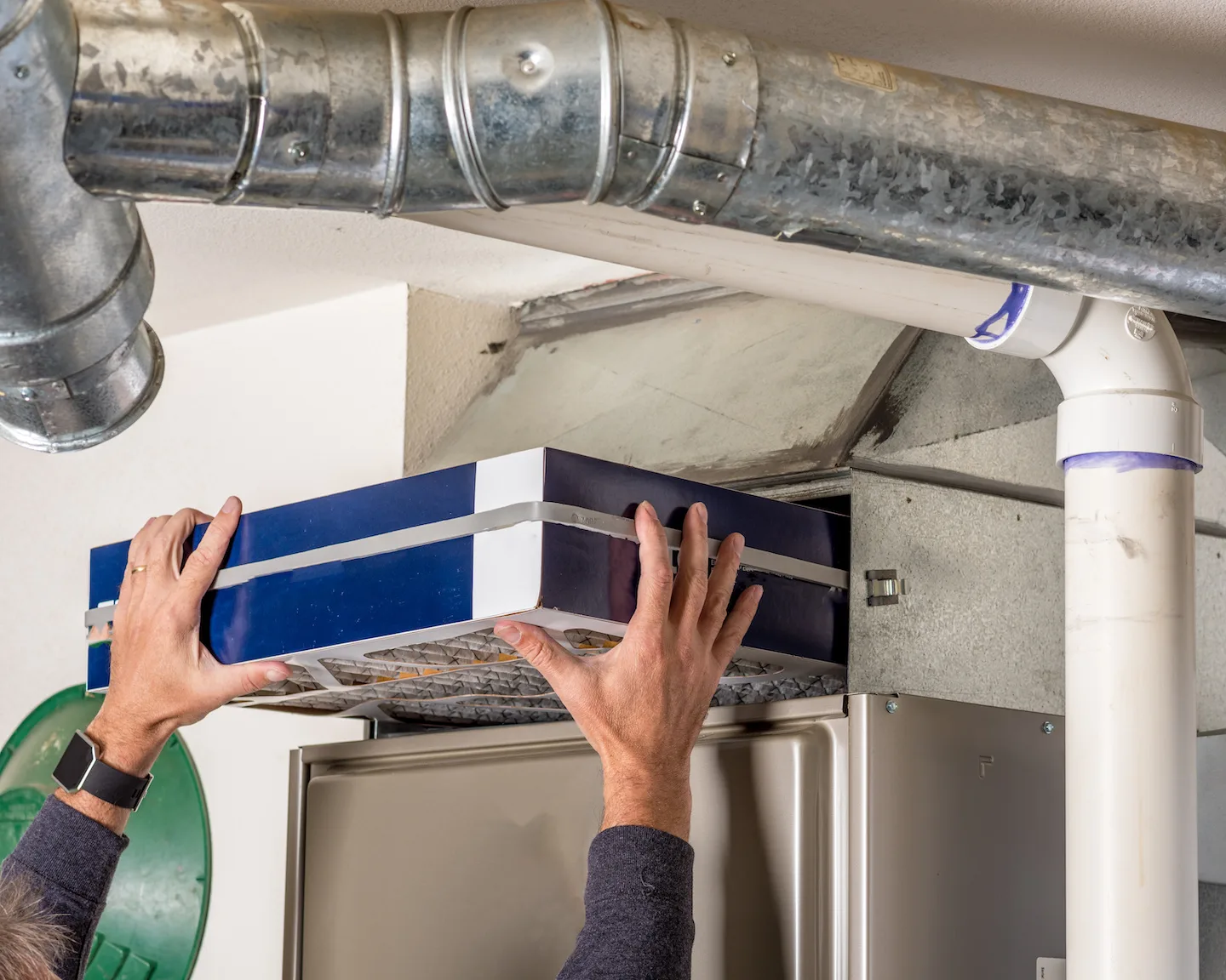 Person replacing air filter in a furnace that won’t turn on.