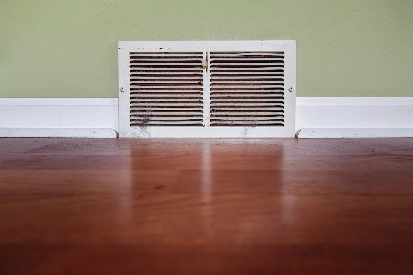 Dirty floor register air vent inside of a home in Lafayette, Louisiana. 