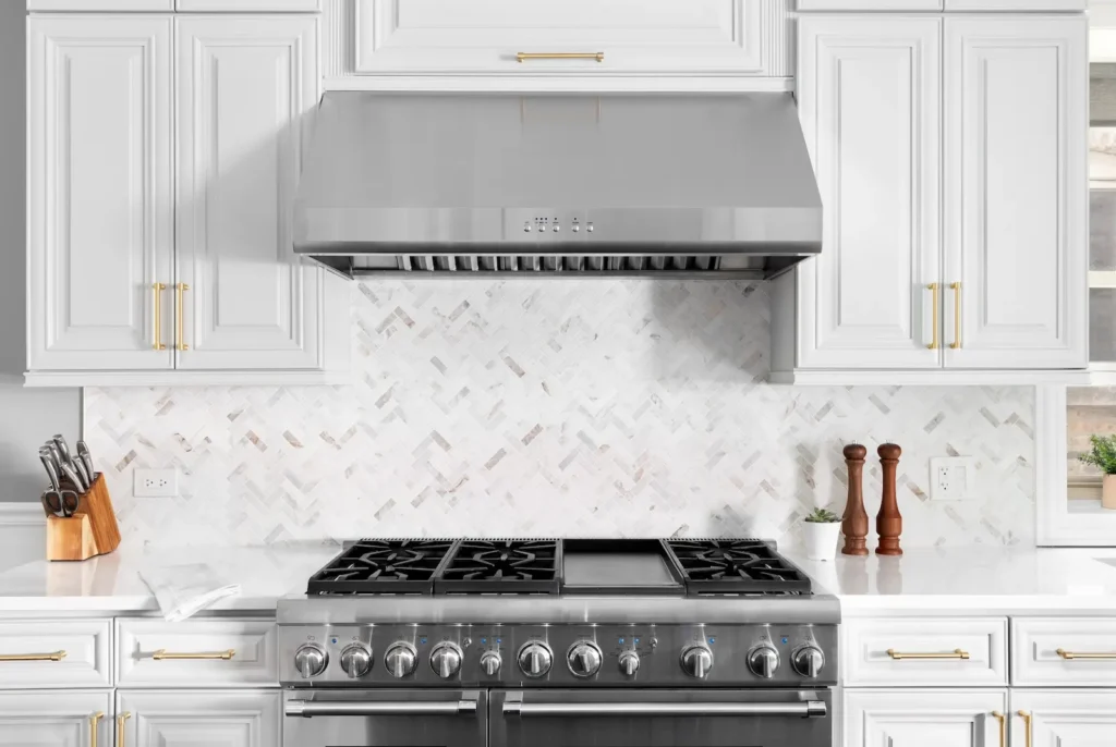 Kitchen vent hood above gas range.