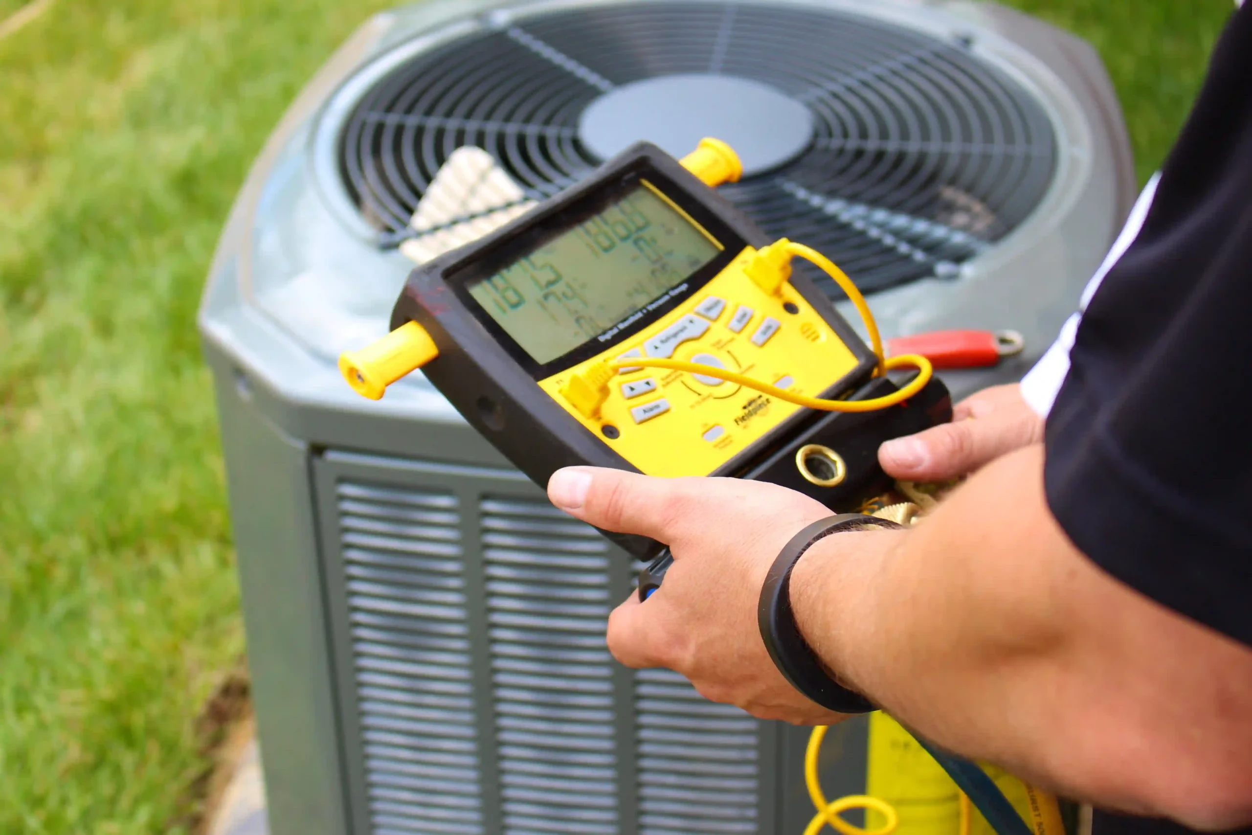 HVAC technician checking outdoor AC unit for repairs.