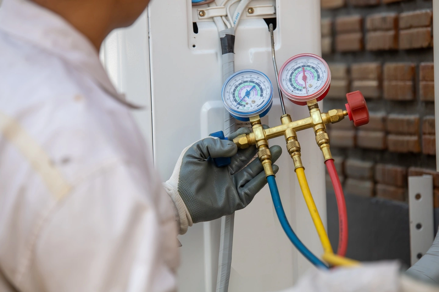 HVAC technician testing an air conditioner to ensure efficient function.
