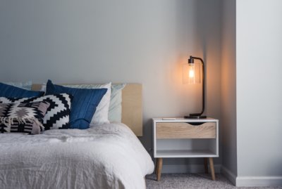 Bed in home with a lamp