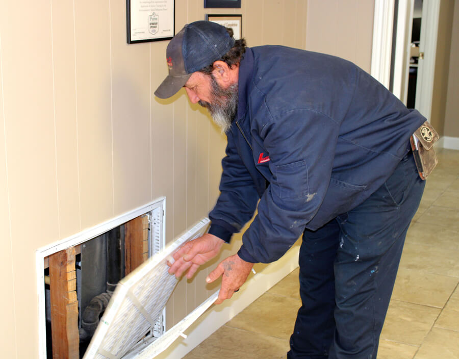 Lee's Air Conditioning company Technician Fixing Air Conditioning Unit