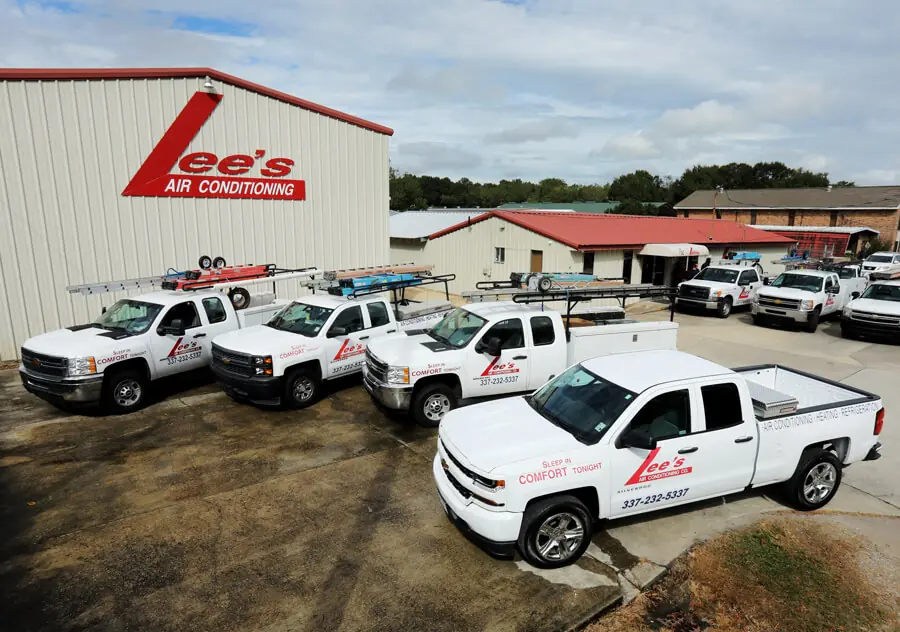 Lee's Air Conditioning Company Trucks Lined Up in Front of Building
