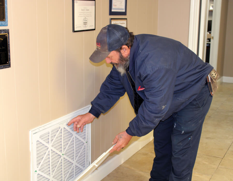 HVAC Technician changing home air filter