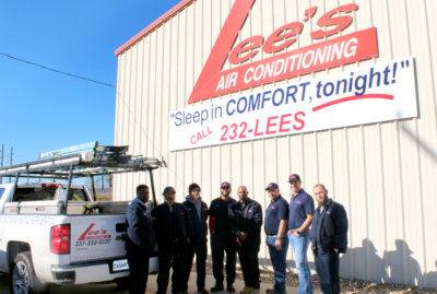 Lee's Air Conditioning Co. Technicians outside Building