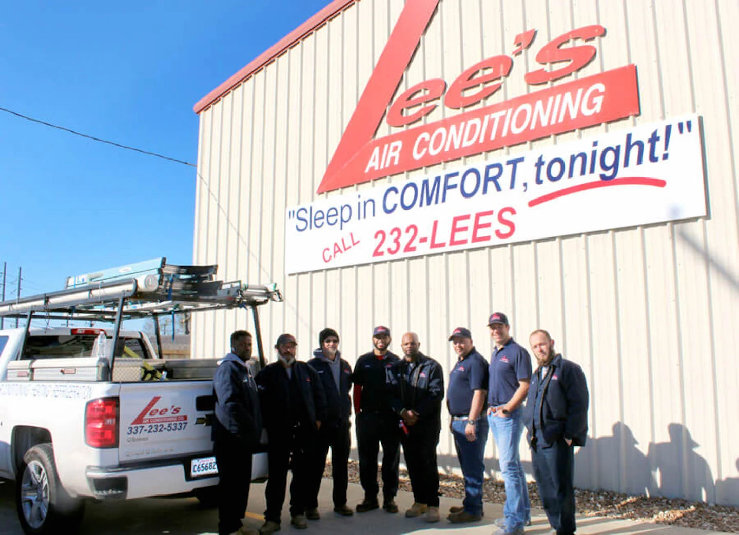 Heat pump technicians at Lee’s in Lafayette standing in front of their office building.