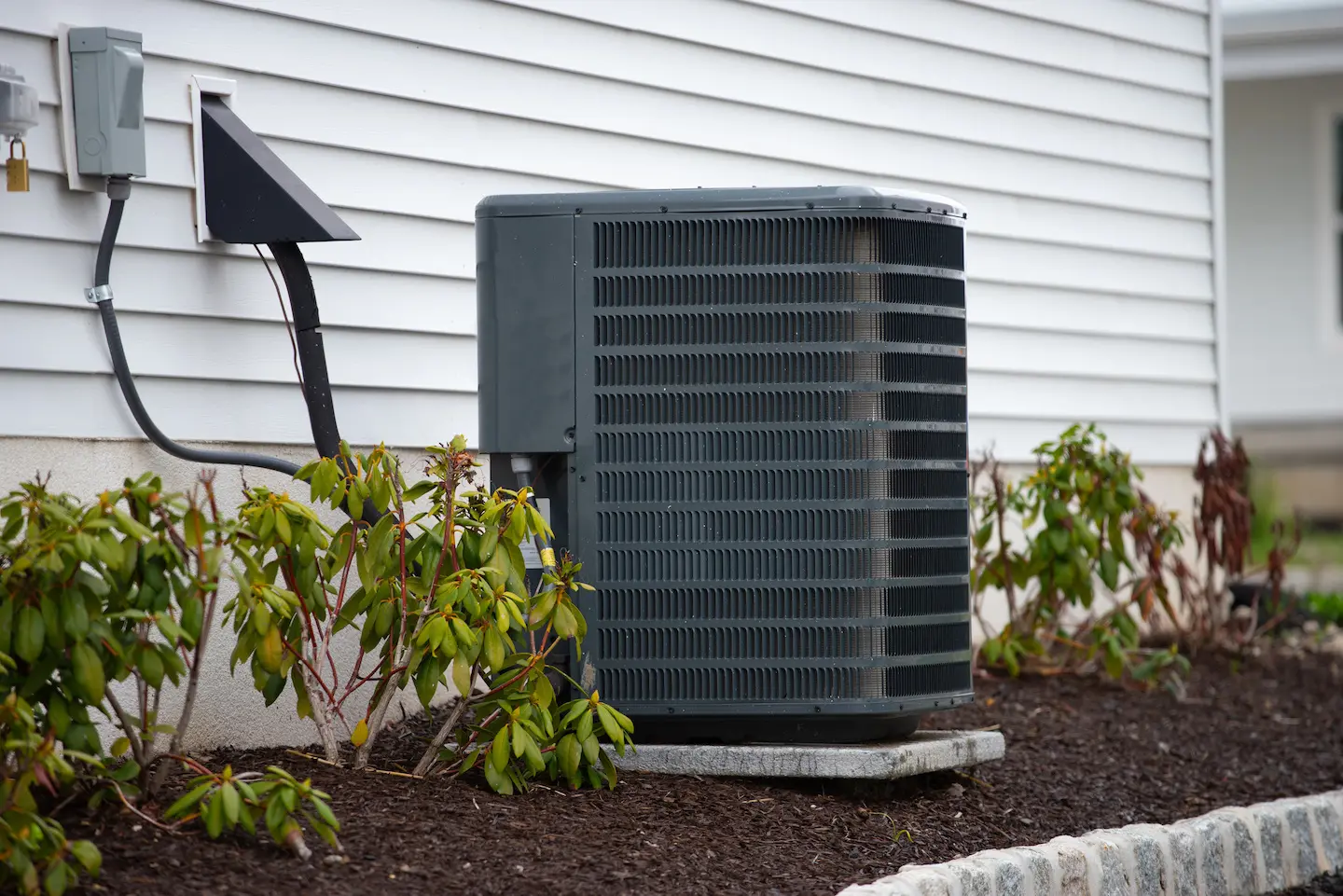 Central air conditioning condenser in yard of home in Lafayette.
