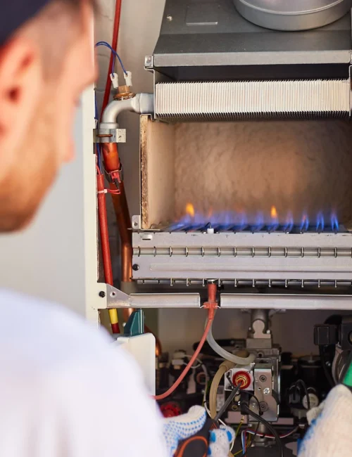 Lee’s Lafayette technician repairing a gas heater.