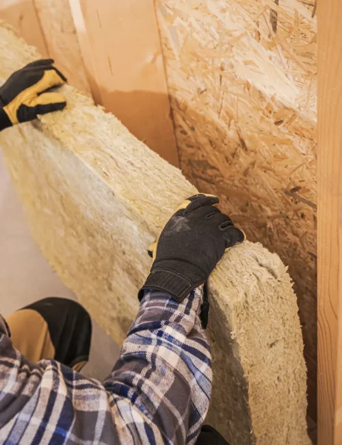 Lee’s technician installing insulation in the attic of a home in Lafayette.